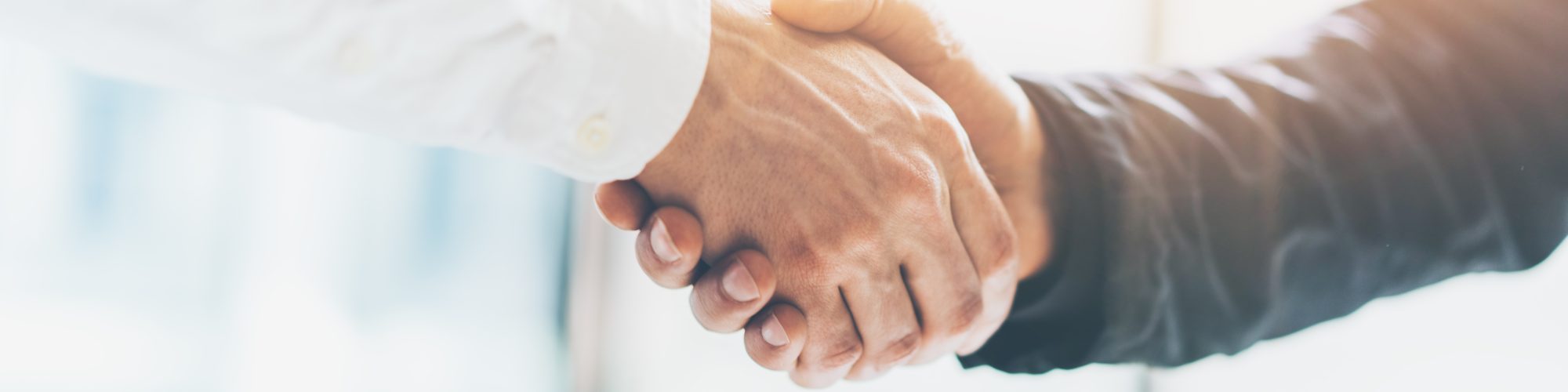 Business partnership meeting. Picture businessmans handshake. Successful businessmen handshaking after good deal. Horizontal, blurred background Business partnership meeting. Picture businessmans handshake. Successful businessmen handshaking after good deal. Horizontal, blurred